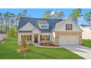 Charming single-story home with brick and white siding, well-manicured lawn, and attached garage at 800 Caines Landing Rd., Conway, SC 29526