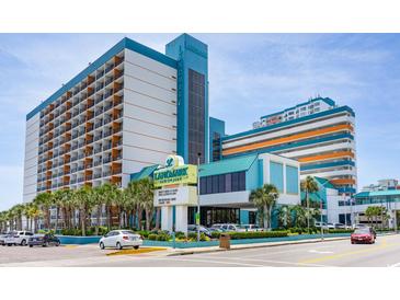 Stunning exterior view of Landmark Resort featuring oceanfront views, palm trees, and covered entrance at 1501 S Ocean Blvd. # 1442, Myrtle Beach, SC 29577