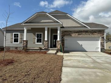 Charming single-story home with stone accents, attached two-car garage, and covered front porch at 541 Honeyhill Loop, Conway, SC 29526