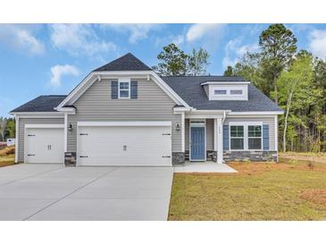 Charming single-Gathering home features gray siding, stone accents, and a two-car garage at 556 Honeyhill Loop, Conway, SC 29526