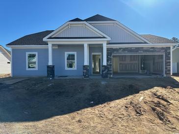 Newly built home with gray siding, stone accents, and a two-car garage at 576 Honeyhill Loop, Conway, SC 29526