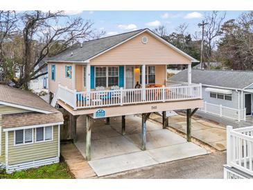 Elevated view of beach house with two stories, deck, and parking underneath at 6001 - 1563 S Kings Hwy., Myrtle Beach, SC 29575