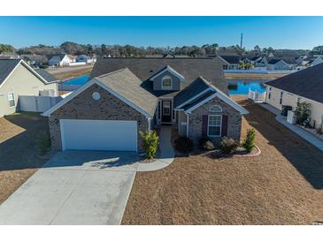 Brick house with a two-car garage and a well-maintained lawn at 1105 Chemung Ct., Surfside Beach, SC 29575