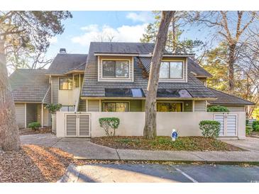 Exterior view of charming townhome with gray siding and a gray roof at 211 Baslow Ct. # 2-C, Myrtle Beach, SC 29572
