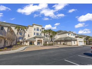 Exterior of a charming three-story building with palm trees and a parking lot at 2180 Waterview Dr. # 637, North Myrtle Beach, SC 29582