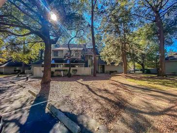 Inviting townhome with manicured lawn and mature trees providing shade and curb appeal at 222 Westleton Dr. # 18-C, Myrtle Beach, SC 29572