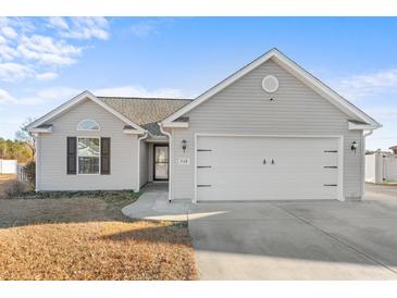 Gray house with a two-car garage and a well-maintained lawn at 248 Hickory Springs Ct., Conway, SC 29527