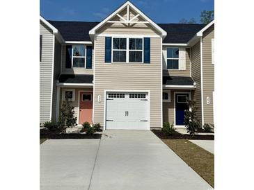 New townhome featuring a garage and colorfully painted front doors at 302 Myrtle Meadows Dr # 511B, Conway, SC 29526