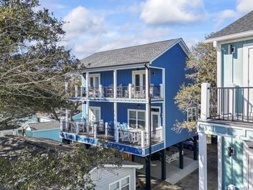 Two-story blue house with large decks, offering ocean views and ample outdoor space at 6001 South Kings Hwy., Myrtle Beach, SC 29575