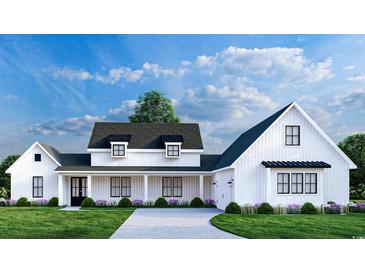 White farmhouse exterior with a large front porch and attached garage at 2172 Pettus Way, Surfside Beach, SC 29575