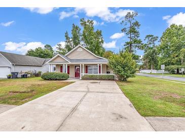 Charming single-story home featuring a well-manicured lawn and a concrete driveway leading to the entrance at 1900 Shell Ct., Surfside Beach, SC 29575