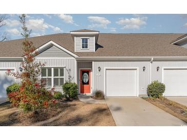 House exterior with gray siding, orange door, and two-car garage at 192 Sea Shell Dr. # 22, Murrells Inlet, SC 29576