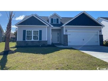 Charming single Gathering home with a manicured lawn and attached two-car garage at 395 Lifestyle Court, Surfside Beach, SC 29575
