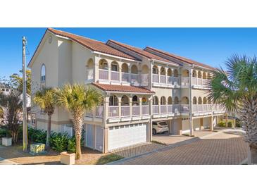 Three-story building with multiple units, each featuring private balconies and garages at 400 Hillside Dr. N # 302C, North Myrtle Beach, SC 29582