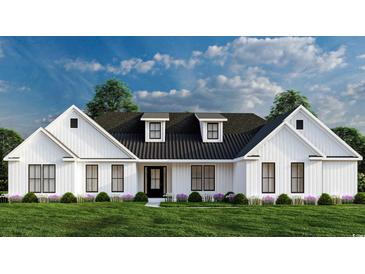 White farmhouse exterior with black roof and landscaping at 2176 Pettus Way, Surfside Beach, SC 29575