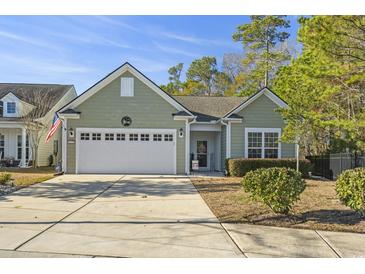 Attractive light green house with a two-car garage and well-manicured lawn at 1115 Prescott Circle, Myrtle Beach, SC 29577