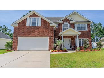 Brick two-story house with a white garage door and landscaped yard at 234 Sugar Mill Loop, Myrtle Beach, SC 29588