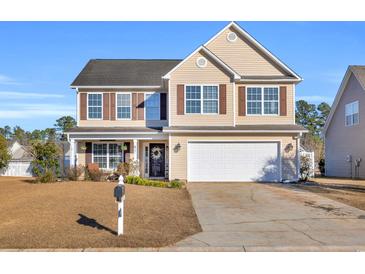 Two-story house with beige siding, brown accents, and a white garage door at 281 Sugar Mill Loop, Myrtle Beach, SC 29579