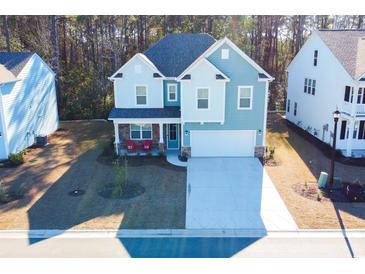 Two-story house with light blue siding, stone accents, and a two-car garage at 3339 Moss Bridge Ln., Myrtle Beach, SC 29579