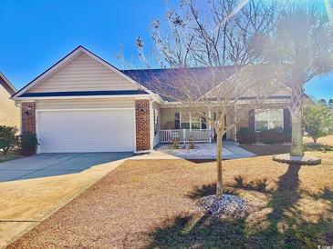 Brick ranch home with attached garage and landscaped yard at 393 Lenox Dr., Conway, SC 29526