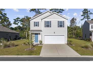 Two-story house with light beige siding, a blue door, and a two-car garage at 219 Marauder Dr., Longs, SC 29568