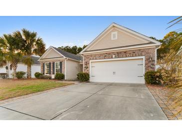 Brick front house with two-car garage and landscaped lawn at 645 Lafayette Park Dr., Little River, SC 29566