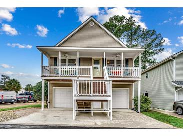 Two-story house with double garage and inviting front porch at 829 9Th Ave. S, North Myrtle Beach, SC 29582