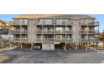 Three-story building with multiple balconies and parking underneath at 9621 Shore Dr. # B-112, Myrtle Beach, SC 29572