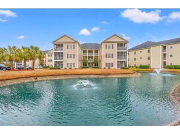 Beautiful condo community featuring manicured landscaping and a tranquil pond with a fountain at 2080 Cross Gate Blvd. # 303, Surfside Beach, SC 29575