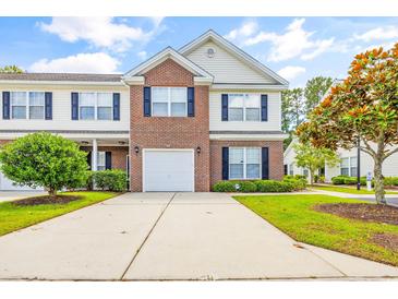 Brick front two-story townhome with attached garage and landscaping at 257 Connemara Dr. # E, Myrtle Beach, SC 29579
