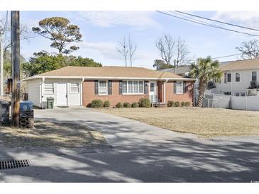 Brick ranch house with attached garage and yard at 408 16Th Ave. S, Myrtle Beach, SC 29577