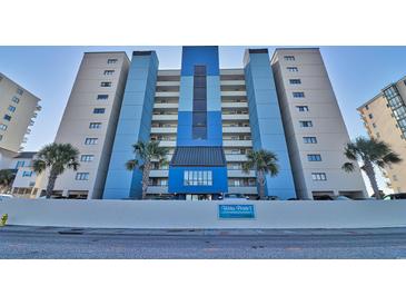 Oceanfront building, featuring blue and white color scheme, with palm trees in front at 4619 S Ocean Blvd. # 706, North Myrtle Beach, SC 29582