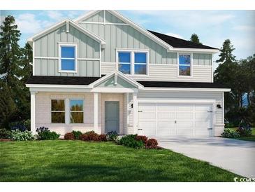 Two-story house with light green and white siding, a large garage, and a well-manicured lawn at 5024 Riverton Ct, Myrtle Beach, SC 29579