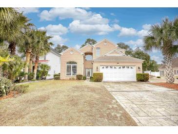 Two-story brick house with a white garage door and landscaped lawn at 508 5Th Ave. S, North Myrtle Beach, SC 29582