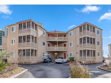 Tan building exterior, with balconies and parking, located near ocean at 600 S Ocean Blvd. # C-21, North Myrtle Beach, SC 29582