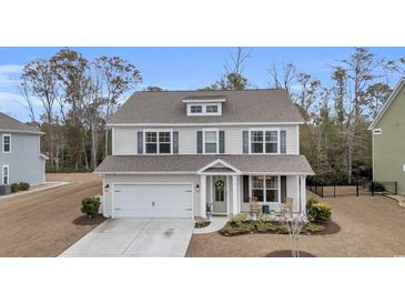 Charming two-story home with a well-maintained front yard and attached garage at 104 Grace Bay Ct., Pawleys Island, SC 29585
