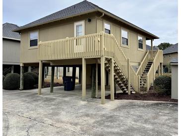 Elevated beach house with deck and stairs at 121 Marshland Ct., Myrtle Beach, SC 29572