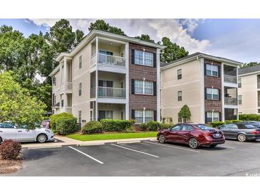 Two-story condo building with ample parking and landscaping at 1302 River Oaks Dr. # 4-F, Myrtle Beach, SC 29579