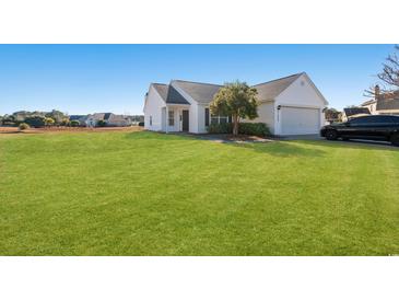 Single-story house with attached garage and spacious lawn at 2209 Beauclair Ct., Myrtle Beach, SC 29579