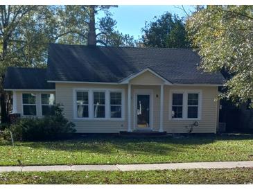 Charming yellow house with a well-maintained lawn and gray roof at 326 East Godbold St., Marion, SC 29571