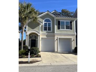 Two-story house with a two-car garage and palm trees at 408 S 7Th Ave. S, North Myrtle Beach, SC 29582