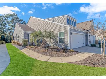 Two-story home with gray siding and landscaped yard at 4348 Livorn Loop # 4348, Myrtle Beach, SC 29579