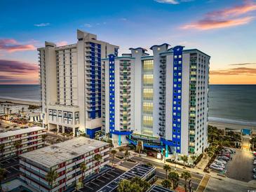 Aerial view of oceanfront resort; two towers, parking lot, and beach at 504 N Ocean Blvd. # 1511, Myrtle Beach, SC 29577