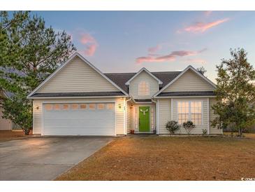 House exterior featuring a two-car garage and well-maintained lawn at 505 White Bark St., Longs, SC 29568