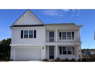 Two-story white house with a gray roof, two-car garage, and front porch at 523 Slaty Dr., Myrtle Beach, SC 29588