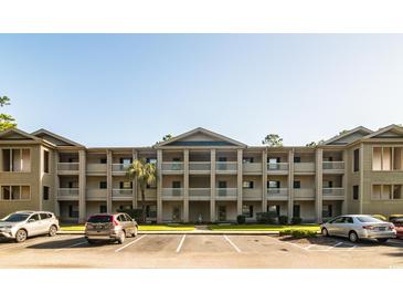 Three-story building with columns and ample parking at 562 Blue Stem Dr. # 54D, Pawleys Island, SC 29585