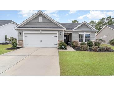 Gray siding house with a two-car garage and landscaped lawn at 688 Tattlesbury Dr., Conway, SC 29526