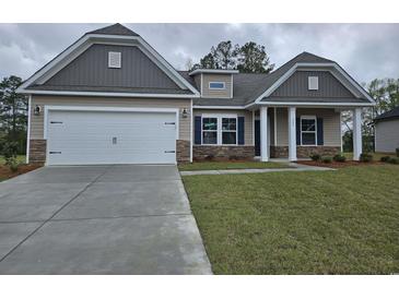 Two-story house with gray and beige siding, stone accents, and a two-car garage at 204 Palmetto Sand Loop, Conway, SC 29527