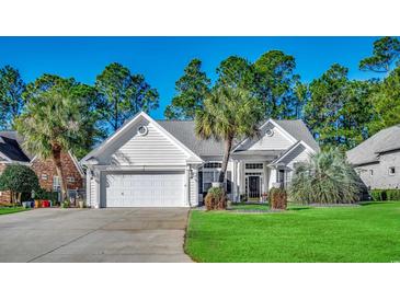 White house with two-car garage and manicured lawn at 4280 Doral Pl., Myrtle Beach, SC 29579