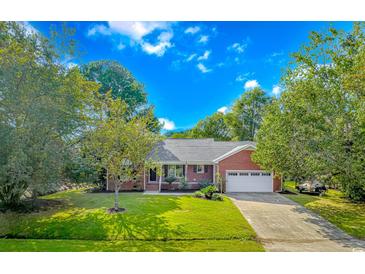 Brick ranch home with attached garage and landscaped lawn at 494 Saluda River Rd., Myrtle Beach, SC 29588